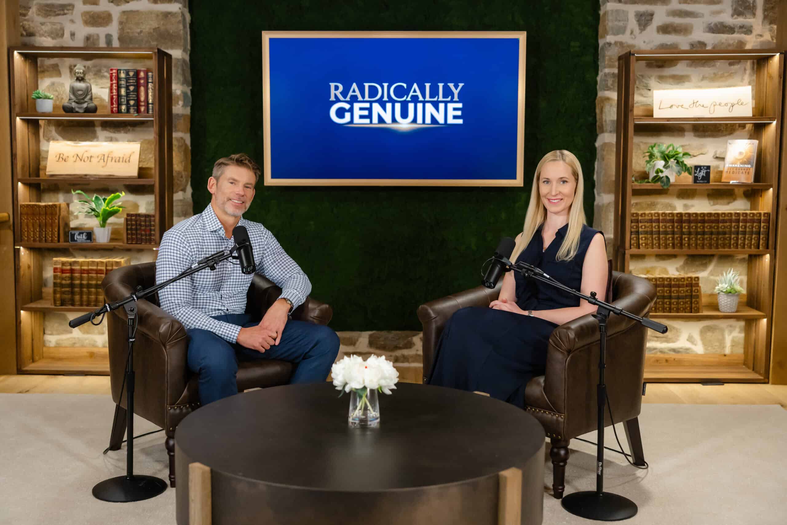 Radically Genuine podcast hosts sitting in studio with microphones and bookshelf backdrop.