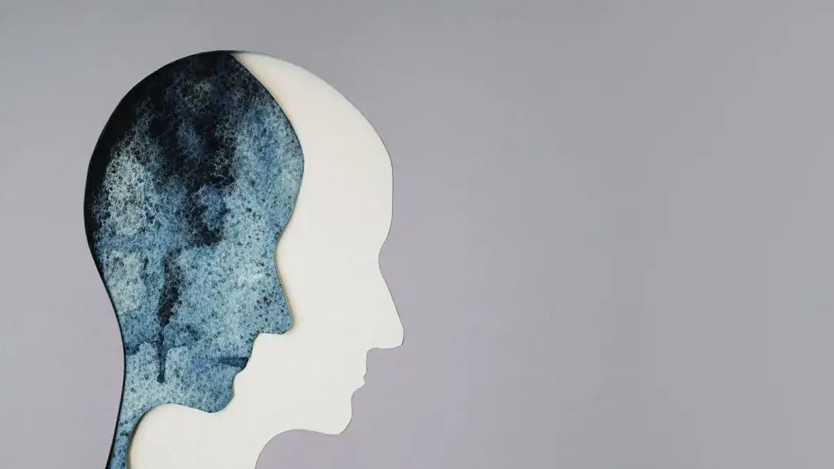 Abstract art of two overlapping human profiles in blue and white tones.